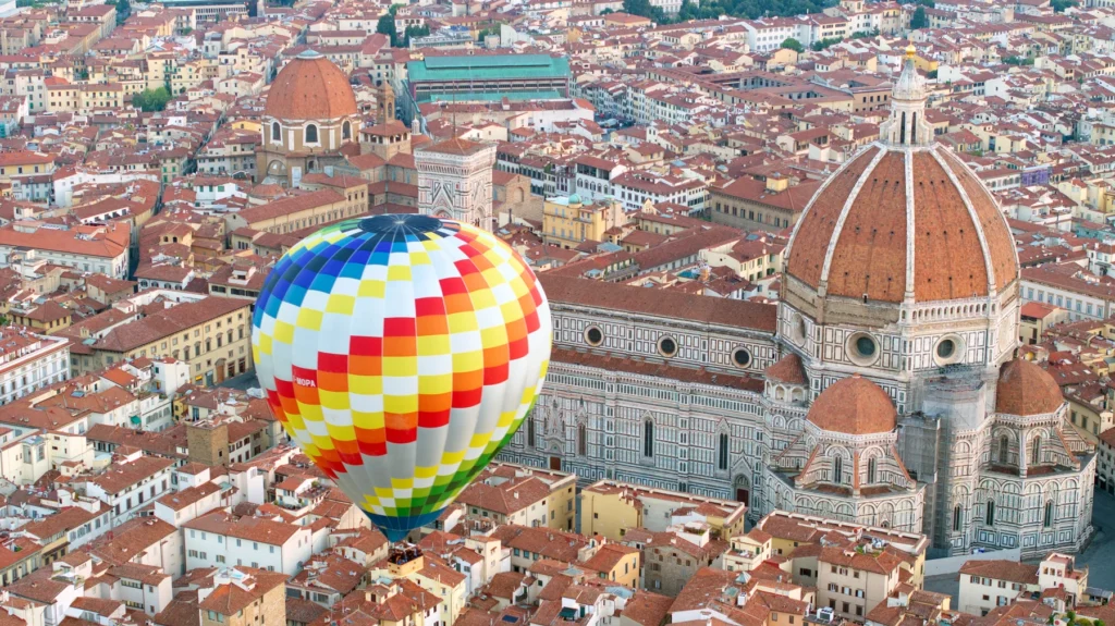 hot air balloon flying over florence and the duomo