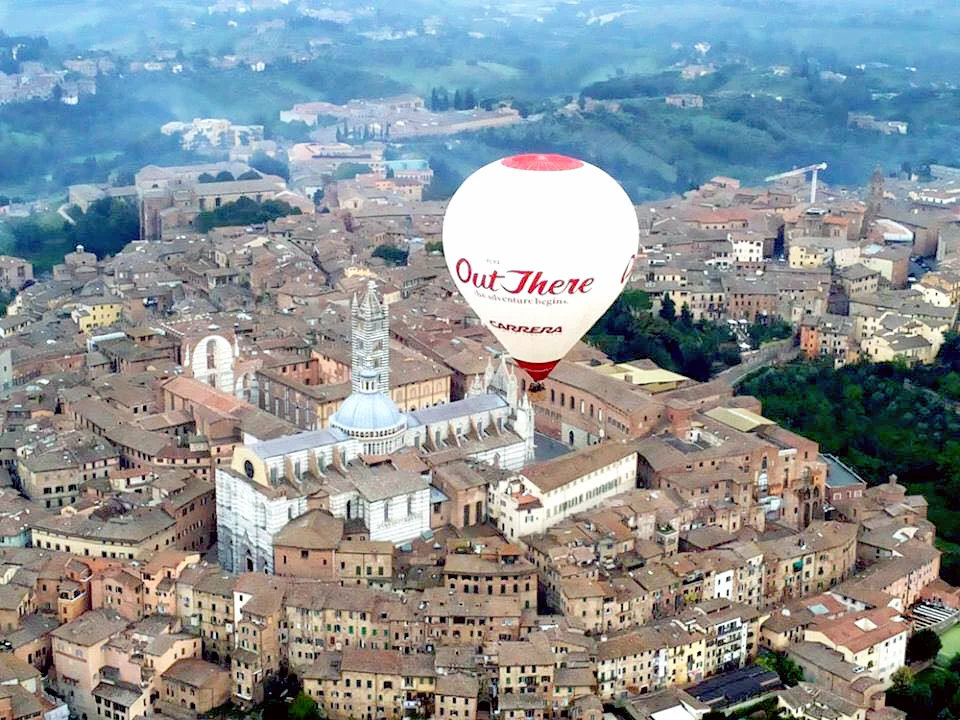 hot air balloon over the city of Siena
