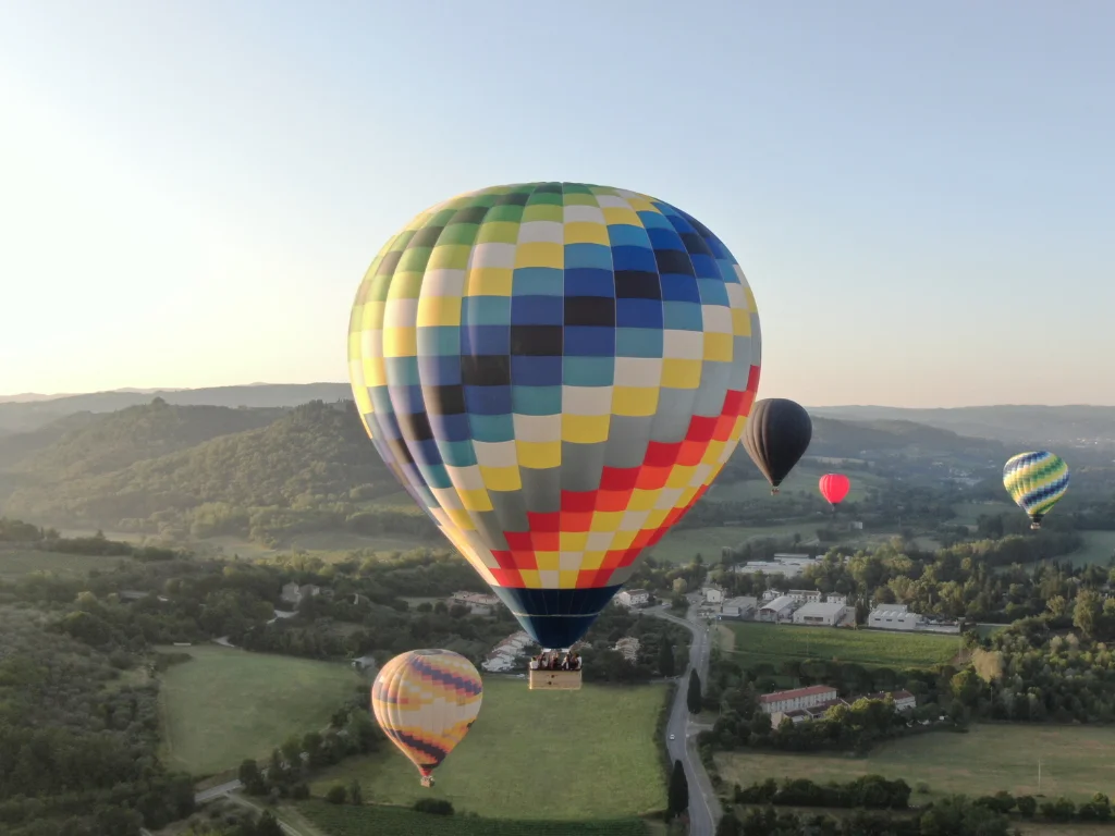 rainbow checkered balloon flying over tuscany